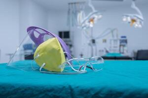 Group of protective headwear for Doctor and Nurse such as surgical mask, face shield and safety glasses before surgery in operating room. photo