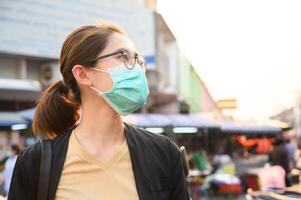 Woman wearing surgical mask for protect bad air pollution or virus in pandemic situations. photo