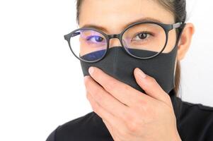 Close up of young Asian woman wearing black mask for protect smog PM2.5 bad air pollution. Air pollution has been associated with diseases of the heart and lungs, cancers and other health problems. photo
