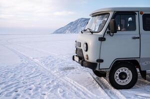 The Russian UAZ van parking on the ice surface of lake Baikal, Russia. Russian UAZ is popular vehicle for ruggedness in the harsh environs of Russia. photo