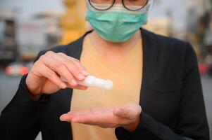 Cropped shot of woman washing hand by hand sanitizer. photo