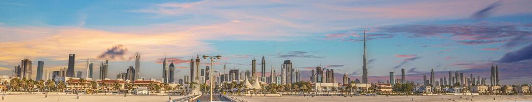 Panoramic image of the illuminated skyline of Dubai at dusk after sunset photo