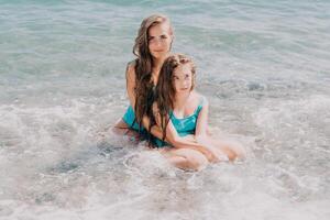 Mother and Daughter Relaxing in the Ocean photo