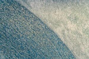 Selective focus. First frost on a frozen car, late autumn close-up. Beautiful abstract frozen microcosmos pattern. Freezing weather frost action in nature. Winter backdrop. photo