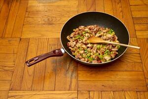 Chinese fried chicken with vegetables in a wok pan photo