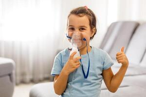 Little girl use inhaler nebulizer. Child asthma inhaler, nebulizer steam, flu or cold concept. Copyspace photo