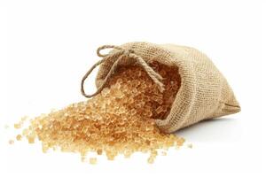 Burlap sack of raw brown sugar spilling out photo