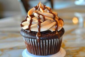 Delicious chocolate cupcake drizzled with chocolate and peanut butter frosting photo