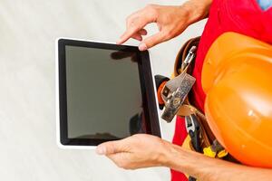 Construction Worker with a tablet. Planning Developer Concept photo