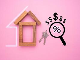 Home loan and real estate investment concept. Small wooden house with image graphic isolated on pink background. Top view photo