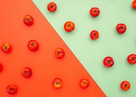 Top view of ripe red acerola cherries fruits isolated on color background. High vitamin C and antioxidant fruits. Top view. Close-up photo. Space for text. Concept of healthy fruits photo