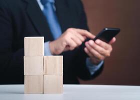 Hand of businessman arranging empty wooden blocks. Close-up photo. Space for text. Business and strategy planning concept photo