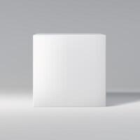 Simple white cube in front view on a gray gradient background, casting shadow. photo