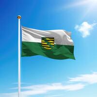 Waving flag of Saxony is a state of Germany on flagpole photo