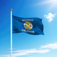 Waving flag of Calabria is a region of Italy on flagpole photo