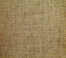 Natural linen material textile canvas Fabric texture background Close-up detail of fabric natural color Hemp material pattern design wallpaper. can be used as background or for graphic design photo