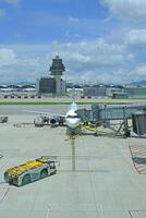 Airport terminal huge glass window with front view of air plane and air traffic control tower photo