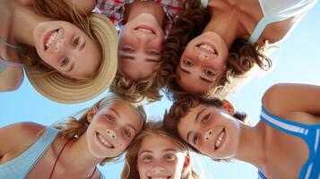 Group of kids forming a circle and smiling to camera photo