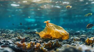 Yellow plastic bag polluting a seabed with some fishes swimming near the surface photo
