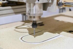 Close-Up of CNC Machine Precisely Cutting and Processing Wooden Boards photo