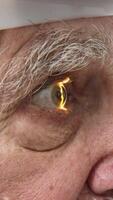 Close-up of a senior man having his vision tested on an ophthalmology diagnostic vision testing equipment. Old man doing eye test with non contact tonometer, checking vision at optical clinic video