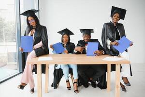 portrait of multiracial graduates holding diploma photo