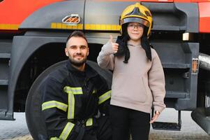 Firefighter holding child boy to save him in fire and smoke,Firemen rescue the boys from fire photo