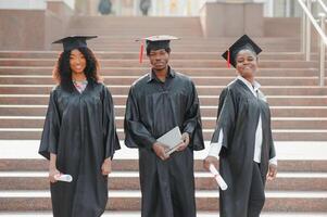 optimistic young university graduates at graduation photo