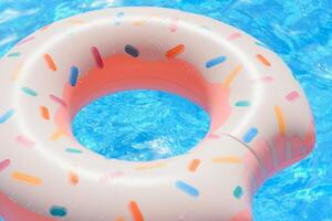 Inflatable swim ring in shape of donut floating in pool photo