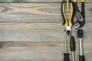 Various tools on wooden background photo