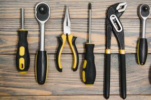 Set of tools over a wood panel with space for text photo