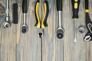 Set of tools over a wood panel with space for text photo