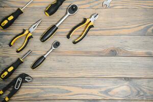 Set of tools over a wood panel with space for text photo