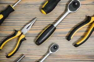 Set of tools over a wood panel with space for text photo