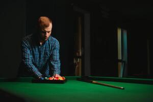 Playing billiard - Close-up shot of a man playing billiard photo