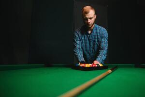 Playing billiard - Close-up shot of a man playing billiard photo