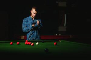 Playing billiard - Close-up shot of a man playing billiard photo