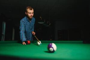 Man playing billiards in a club photo