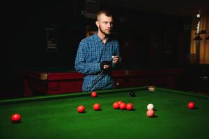 Man playing billiards in a club photo