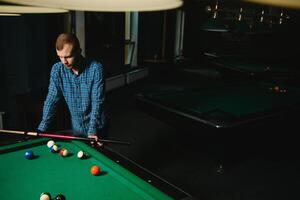 Playing billiard - Close-up shot of a man playing billiard photo