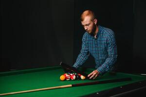 Man playing billiards in a club photo