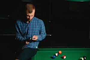 Man playing billiards in a club photo