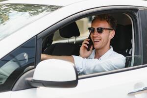 Man sitting at the wheel of electric car photo