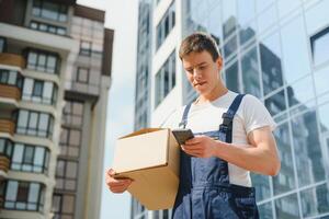 Postman with parcel box. Postal delivery service. photo