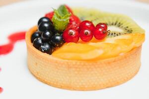 Delicious cheesecake with berries on table close up photo