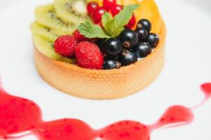 Delicious cheesecake with berries on table close up photo