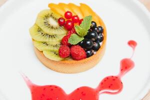 Delicious cheesecake with berries on table close up photo