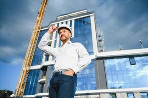 A construction worker control in the construction of roof structures on construction site and sunset background photo