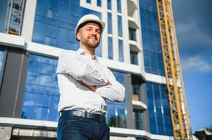A construction worker control in the construction of roof structures on construction site and sunset background photo