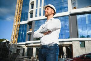 Industrial theme constructor standing at a site area. photo